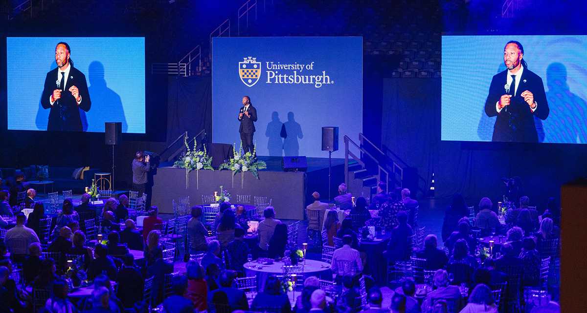 Pro Football Hall of Famer Larry Fitzgerald Jr. speaks onstage to the event crowd 